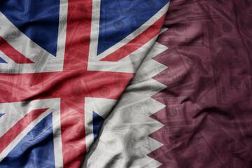 big waving colorful flag of qatar and national flag of great britain on the dollar money background. finance concept.