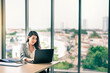 © totojang1977 - Happy attractive Asian business woman working with a laptop and financial document at office, successful action, Business concept.