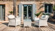 © lililia - a modern outdoor terrace featuring white rattan chairs and a glass table on a wooden deck, surrounded by a stone wall, with a sunken seating area for relaxation.
