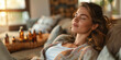 © Oleksandr - A beautiful young woman relaxes in a carriage while aromatherapy oils freshen the air in the living room at home.