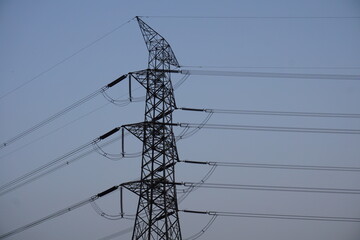 High voltage electricity transmission tower with the copy space, Electricity distribution pylon under the sky, Electricity transmission tower with blue sky background