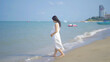 © tampatra - A portrait of happy Asian pregnant woman at sea shore beach. Having a baby. Family people lifestyle. Mom love.