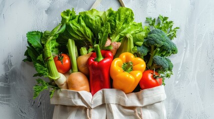 Wall Mural - Close up shot of a variety of fresh vegetables in an eco friendly bag against a light background