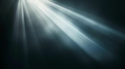 Wall Mural - Rays of light shining through a dark background creating a dramatic and ethereal effect