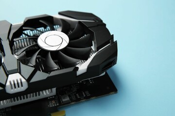 Poster - Computer graphics card on light blue background, closeup. Space for text