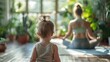 © tashechka - A toddler observes their mother meditating in a sunlit indoor space filled with plants, creating a serene atmosphere.