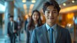 © Mr. Muzammil - confident and handsome businessman with a friendly smile in a Modern office blurred background