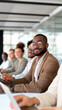 © StirfryMoJi - A confident professional smiling and attending a meeting with colleagues in an office.