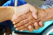 © adi yuhanggana - wrinkled elderly hands, holding hands, elderly hands, elderly people shaking hands, shaking hands