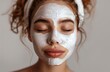 © pornsawan - Beautiful woman enjoying of a facial mask treatment with a facial disc,cream on her face,Female taking care of her face skin.