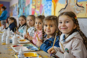 Wall Mural - A group of young girls are painting at a table
