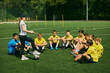 © master1305 - Team Strategy Session. Young soccer players studying with their coach, emphasizing educational and strategic aspects of sports training. Concept of sport, school, childhood, hobby, active lifestyle