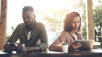 Cafe, couple and ignore with technology after conflict, argument and misunderstanding outdoor. Dating people, man and angry woman with tablet, affair and cheating guy on smartphone in relationship