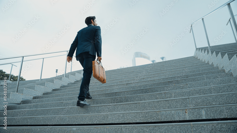 Top view of smart business man walking up stairs with bag in the hand ...