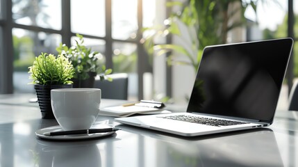 Wall Mural - A high-resolution image of a modern office workspace with a sleek laptop, a stylish cup of coffee, a potted plant, and a notebook with a pen