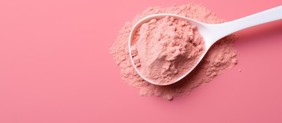 Canvas Print - Top down view of a scoop with protein powder on a pink background forming a sports nutrition minimal concept with copy space image