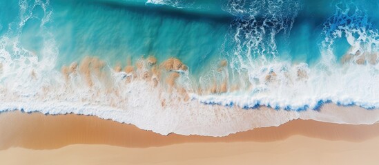 Top view of a scenic coastal seascape with a pristine beach deep blue waters and powerful waves perfect for a travel or vacation copy space image