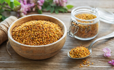 Healthy bee pollen grains.  Bee pollen on a bowl and acacia flowers.