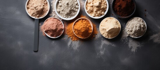 Poster - Set of sports nutrition items including protein powder scoop on gray stone background viewed from above with copy space image available