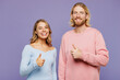 © ViDi Studio - Young smiling satisfied happy couple two friends family man woman wear pink blue casual clothes together showing thumb up like gesture isolated on pastel plain light purple background studio portrait.