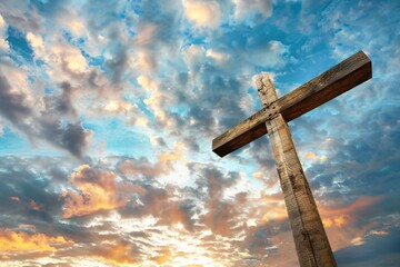 Old wooden cross stands proudly in front of a beautiful and dramatic sunset, representing faith, hope, and the divine