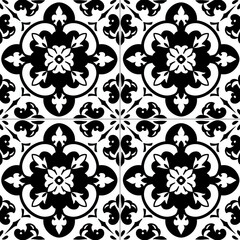 Black and white ceramic tiles with floral and geometric patterns.