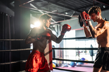 Two young professional boxer having a competition tournament on stage. 