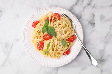 Wall Mural - Tasty pasta with tomato, cheese and fork on white marble table, top view