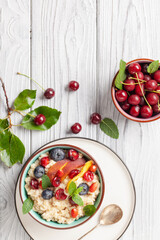 Wall Mural - Oatmeal cereal with berries in a bowl on the table. A healthy breakfast. Baby food.