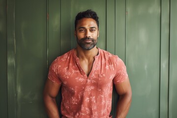 Wall Mural - Portrait of a satisfied indian man in his 30s donning a trendy cropped top isolated in scandinavian-style interior background