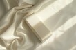 © Krisartist94 - White box on cream-colored fabric in soft natural light
