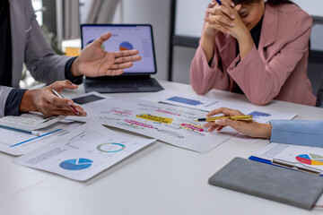 Wall Mural - Group of casually dressed asian businesspeople discussing ideas in the office. Creative professionals gathered at the meeting table for discuss important issues of the new successful startup project	