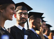 © Hira/peopleimages.com - College, graduation and portrait of student man outdoor with friends for ceremony or event together. Diversity, education and success with happy graduate on academy campus for development or future