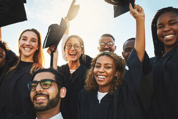 Canvas Print - Group, graduates and diversity at university graduation, happiness for degree or diploma certificate. Team, students and celebrating for academic achievement at college campus, smile for knowledge