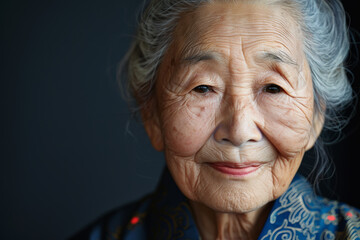 Wall Mural - Close-up portrait of elderly Asian woman, studio photo