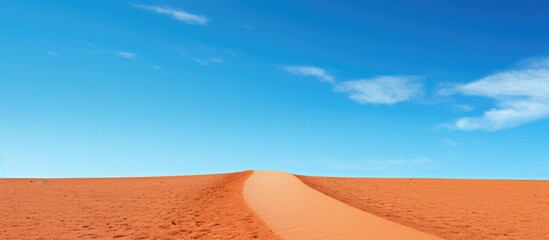 Fototapete - Red color sand pathway picture Natural blue sky background. Creative banner. Copyspace image
