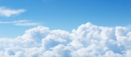 Poster - Soft white clouds against blue sky background and empty space. Creative banner. Copyspace image