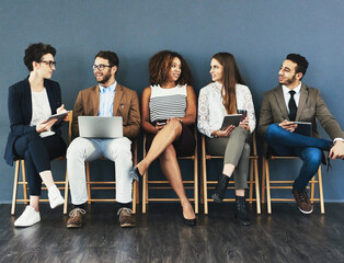 Canvas Print - Discussion, technology and business people in waiting room for interview, meeting or recruitment on chair. Hiring, HR and diversity candidates in office for opportunity, onboarding or employment