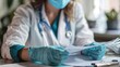 © easybanana - A doctor wearing a mask and gloves is reviewing a clipboard with medical records.