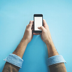 Poster - Phone screen, mockup and hands of man in studio with social media, streaming or subscription on blue background. Smartphone, space and person with app for online, competition or gaming sign up promo