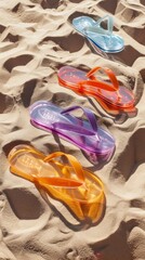 Poster - Four pairs of colorful flip flops on a sandy beach