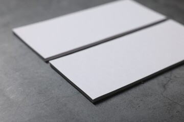 Wall Mural - Blank business cards on grey textured table, closeup. Mockup for design