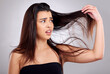 © peopleimages.com - Hair care, frustrated and woman in studio with problem for cosmetic crisis, hairstyle or split ends with white background. Damaged, beauty and model for hairloss, salon stress or tangle strand