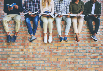 Poster - University student, group and books on wall with legs, learning and progress for development at campus. People, friends and scholarship for education, information and knowledge for future at college
