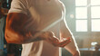 © chekart - A muscular man in a white T-shirt holds a handful of white pills in capsules in his hand. The doping scandal. Close-up. Taking medications