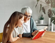 © Lumos sp - grandchild family child grandparent grandmother book reading elderly granddaughter girl  happy together read learning education woman