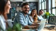 © Alice a. - A group of people are sitting around a table with laptops and smiling. Scene is positive and friendly, as the people seem to be enjoying each other's company while working on their laptops