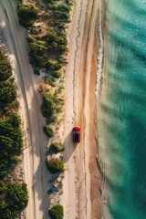 Wall Mural - Aerial View of Red Car Driving Along Coastal Road with Clear Blue Ocean Water