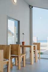 Wall Mural - Cafe interior with wooden furniture and potted plant