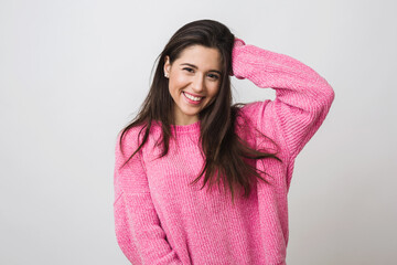 Wall Mural - young and beautiful woman in pink warm sweater, natural look, smiling, portrait on white studio background, isolated, long hair, happy